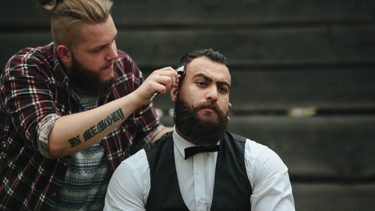 Barber in Vaughan shaves a bearded man in vintage atmosphere