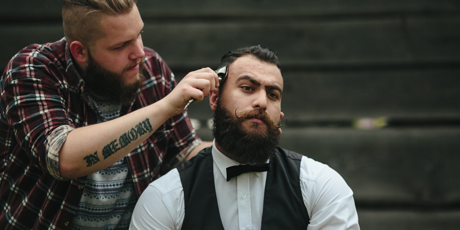 Barber in Vaughan shaves a bearded man in vintage atmosphere