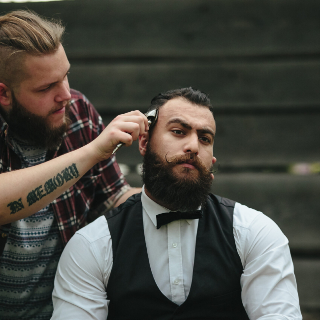 Barber in Vaughan shaves a bearded man in vintage atmosphere